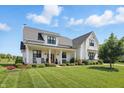 Charming two-story home with a covered front porch, perfect for relaxing and enjoying the outdoors at 6882 Bladstone Rd, Noblesville, IN 46062