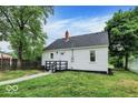 Home's backyard presents a white picket fence and lush lawn space perfect for outdoor activities at 701 E Memorial Dr, Muncie, IN 47302
