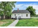 Cozy backyard features freshly painted white siding and a new backyard deck at 701 E Memorial Dr, Muncie, IN 47302