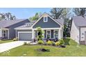 Charming single-Gathering home featuring a gray color scheme, well-manicured lawn, and attached garage at 7154 Covington St, Lebanon, IN 46052
