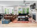 Cozy living room featuring hard wood floors, neutral walls, fireplace, and plenty of natural light at 7154 Covington St, Lebanon, IN 46052