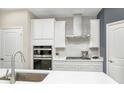 A modern kitchen featuring white cabinets, stainless steel appliances, and a subway tile backsplash at 7177 Firestone Rd, Whitestown, IN 46052