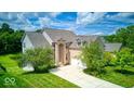 Well-maintained two-story brick home with attached two-car garage and beautifully landscaped front yard at 7212 Maple Bluff Pl, Indianapolis, IN 46236