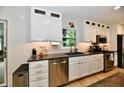 Bright kitchen with stainless steel appliances, black countertops, and modern white cabinetry at 7242 Highburry Dr, Indianapolis, IN 46256