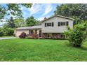 Inviting two-story home featuring a lush green lawn, brick accents, and an attached two-car garage at 7504 Troon Ct, Indianapolis, IN 46237