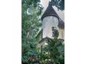 Unique architectural design featuring a turret and lush greenery surrounding the property at 783 Woodruff Place Middle Dr, Indianapolis, IN 46201