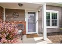 Inviting front entrance with a decorative welcome sign and charming decor at 9700 River Oak E Ln, Fishers, IN 46038