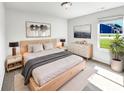 Serene bedroom featuring natural wood furnishings and a sunlit window at 10112 James Run Dr, Indianapolis, IN 46239