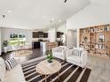 Bright living room with modern furnishings flowing into a sleek kitchen area at 10112 James Run Dr, Indianapolis, IN 46239