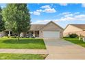 Charming brick home featuring a well-manicured lawn, two-car garage, and inviting front porch at 1056 Hilltop Commons Blvd, Whiteland, IN 46184