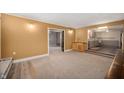 Inviting living room features fresh paint, carpet and an open design flowing into the kitchen with updated cabinets at 106 N Jamalee Way, Pendleton, IN 46064