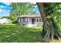One-story home with well-manicured front lawn and mature trees at 11 14Th St, Franklin, IN 46131