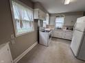 Bright kitchen with white cabinets, tile floors, and modern appliances at 114 S Green St, Brownsburg, IN 46112