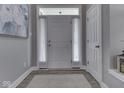 Bright foyer with grey walls, white trim, and wood-look floors at 1215 W Curry Rd, Greenwood, IN 46143