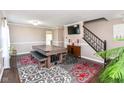 Spacious game room featuring a billiards table, dark floors, and an elegant area rug at 12343 Slate Dr, Fishers, IN 46037