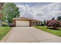 Charming home featuring a spacious driveway and manicured landscaping, perfect for a Gathering at 12515 Traverse Pl, Fishers, IN 46038