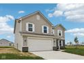 Well-maintained two-story house featuring a two-car garage, lush lawn, and pristine landscaping at 1304 Vera Blvd, Danville, IN 46122
