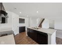 Modern kitchen with black appliances, dark cabinets, white countertops and wood floor at 1304 Vera Blvd, Danville, IN 46122