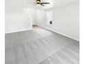 Bright living room showcasing plush carpeting, a ceiling fan, a staircase, and a large window for natural light at 1525 Bluestem Dr, Greenwood, IN 46143