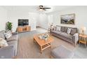 Cozy living room boasts neutral walls, plush sofas, ceiling fan, area rug, and stylish furnishings for comfortable living at 1525 Bluestem Dr, Greenwood, IN 46143