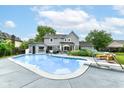 Large backyard pool, with diving board, pool-house, and lounge chairs offers a private, relaxing outdoor space at 164 Wellington Pkwy, Noblesville, IN 46060