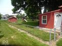 Spacious fenced backyard with a shed, play set, and ample space for recreation at 213 S Coventry Dr, Anderson, IN 46012