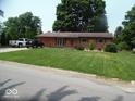 Lovely single-story home showcasing a lush front yard and classic brick facade at 213 S Coventry Dr, Anderson, IN 46012
