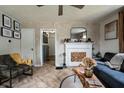 Cozy living room features a decorative fireplace, stylish furniture, and a ceiling fan at 250 N 18Th Ave, Beech Grove, IN 46107