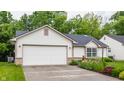 Delightful single-Gathering home featuring an attached garage and lush green lawn, creating a welcoming appeal at 4103 Caddy Way, Indianapolis, IN 46268