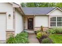 Inviting front entrance with charming landscaping, enhancing the curb appeal of this lovely home at 4103 Caddy Way, Indianapolis, IN 46268