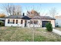Charming single-story home with an autumn tree and an attached garage at 4108 Patricia St, Indianapolis, IN 46222
