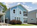 Charming two-story home with light blue siding, a small porch, and a well-maintained front yard at 422 Sanders St, Indianapolis, IN 46225
