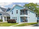 Charming two-story home with light blue siding, a small porch, and a well-maintained front yard at 422 Sanders St, Indianapolis, IN 46225