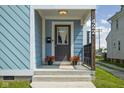 Close-up of the home's charming front porch with decorative plants and a welcoming entrance at 422 Sanders St, Indianapolis, IN 46225