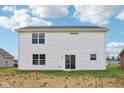 Backyard view of a white siding home with several windows and a glass sliding door at 5002 Amber Wood Dr, Lawrence, IN 46235
