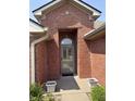 Inviting front entryway featuring a brick archway and a stylish storm door at 5148 Constitution Ct, Columbus, IN 47203