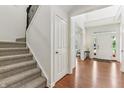 Bright foyer featuring hardwood floors, a staircase with iron balusters and an open floor plan at 5441 Ellsworth Dr, Plainfield, IN 46168