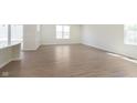 Bright living room with wood-look floors and plenty of natural light from large windows at 7151 Stetson Dr, Whitestown, IN 46052