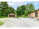 This property has a spacious backyard with a gravel area and a detached garage, perfect for outdoor activities at 7829 Rahke Rd, Indianapolis, IN 46217