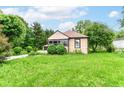 Charming single-story home with green lawn and shrubbery, offering classic curb appeal in a serene environment at 7829 Rahke Rd, Indianapolis, IN 46217
