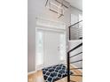 Bright foyer featuring a modern light fixture, staircase, and a patterned rug at 8425 Codesa Way, Indianapolis, IN 46278