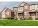 Charming brick townhouse with a well-manicured lawn and inviting front entrance at 8425 Codesa Way, Indianapolis, IN 46278