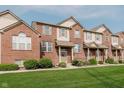 Charming brick townhouse with a well-manicured lawn and inviting front entrance at 8425 Codesa Way, Indianapolis, IN 46278