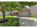 Brick home with manicured lawn, an attached garage, and a cozy, inviting curb appeal at 8447 Wanda Lake Dr, Camby, IN 46113