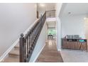 Spacious foyer featuring a view of the dining area and a dark wood staircase at 8556 N Deer Hill Dr, McCordsville, IN 46055