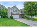 Well-maintained two-story home with a spacious lawn, attached two-car garage and beautiful siding and brick accents at 9605 Treyburn Green Way, Indianapolis, IN 46239