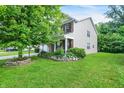 Beautiful landscaping surrounds this inviting two-story home, which also features an attached two-car garage at 9605 Treyburn Green Way, Indianapolis, IN 46239