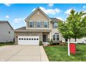 Beautiful two-story home with stone accents, an attached garage, and manicured landscaping at 10306 Mcclain Dr, Brownsburg, IN 46112