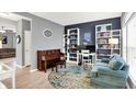 Stylish living room featuring a piano, bookshelves, modern decor, and ample natural light at 10306 Mcclain Dr, Brownsburg, IN 46112