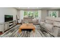 Cozy living room with comfortable seating and a large window overlooking the greenery at 11802 Prairie Pl, Carmel, IN 46033